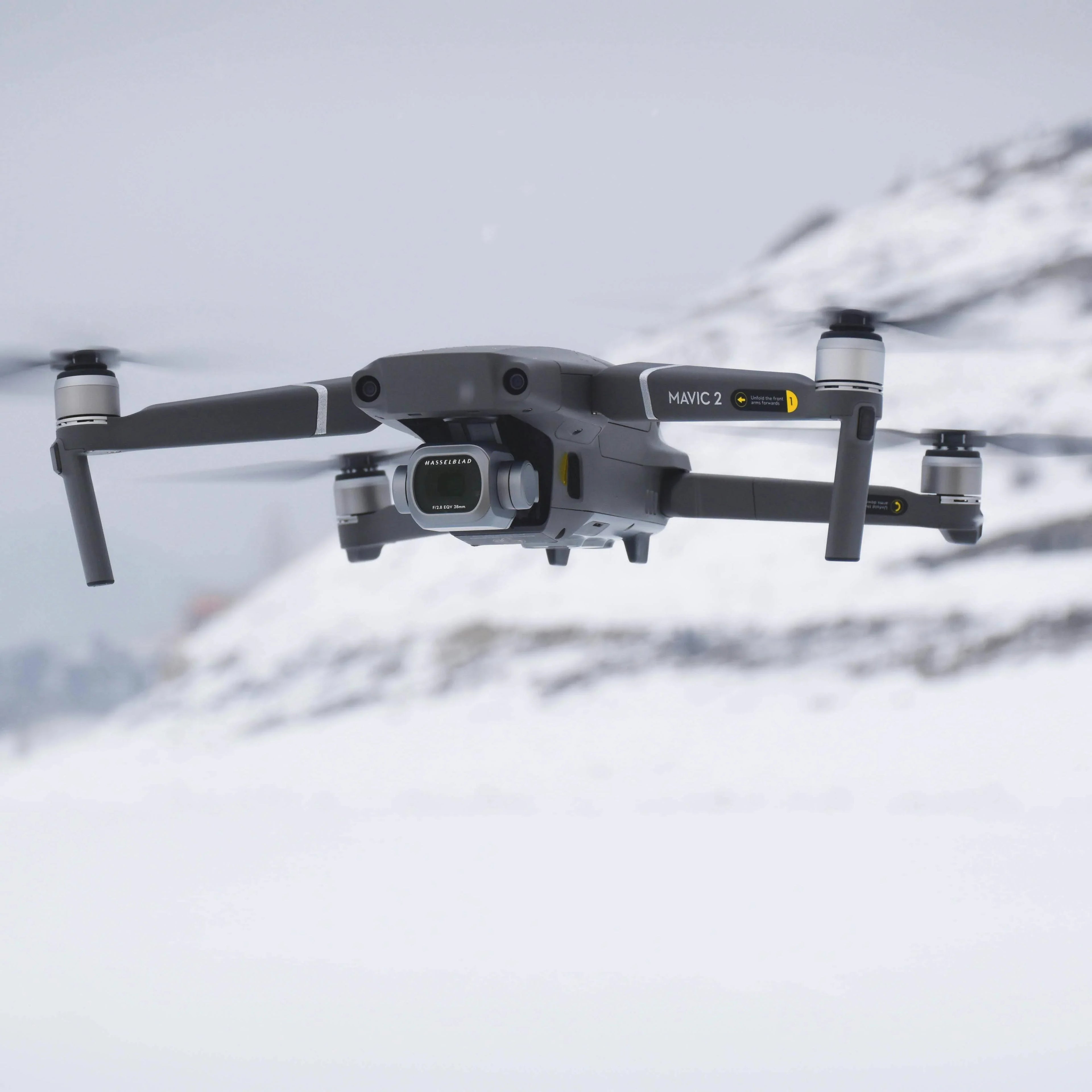 DJI Mavic 2 drone flying over snowy mountain landscape with Hasselblad camera