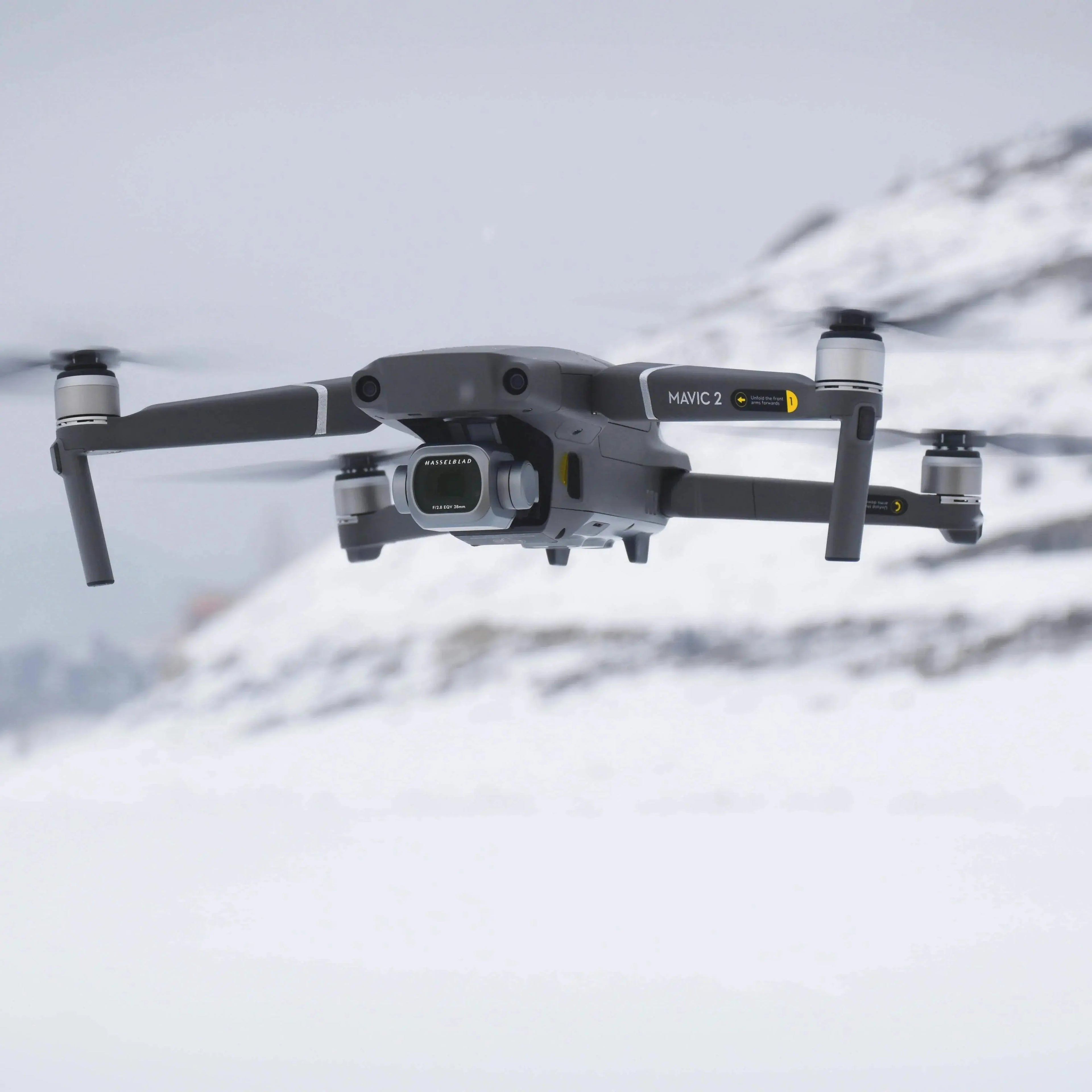 DJI Mavic 2 drone flying over snowy mountain landscape with Hasselblad camera