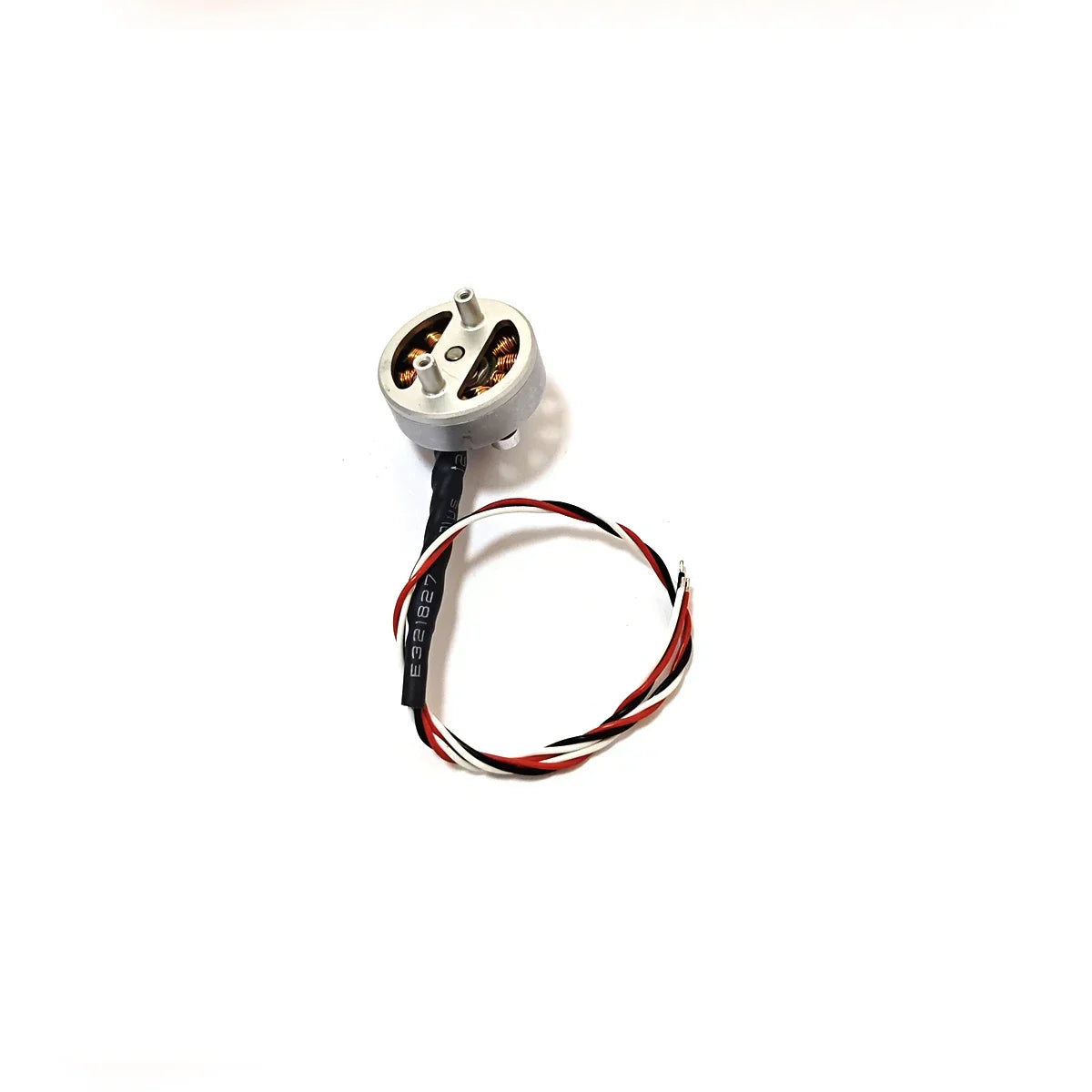Small round brushless motor with copper coils and red black white twisted wires on white background