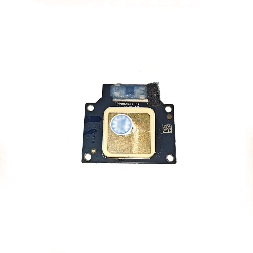 Close-up of a small electronic sensor module with a gold square sensor and a blue protective cover on a white background