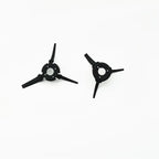 Two black three-pronged brush replacement parts for robot vacuum cleaner on white background