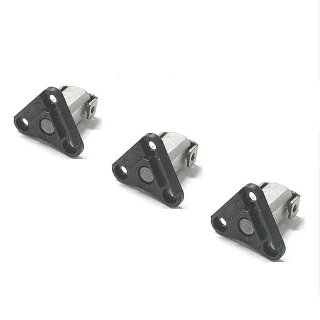 Three automotive ignition control module sensors with black triangular mounts on a white background