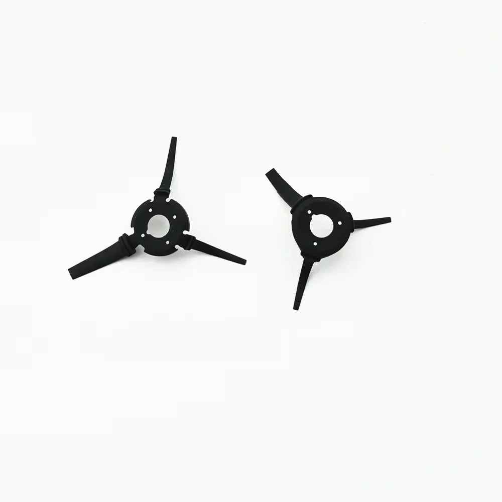 Two black three-blade replacement side brushes for robot vacuum cleaner on white background