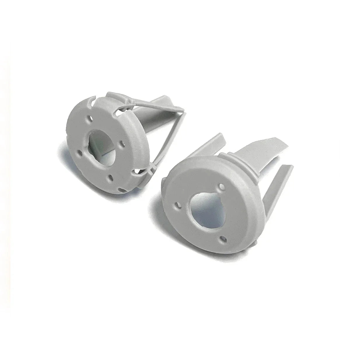 Two white plastic fasteners with round heads and prongs on a white background