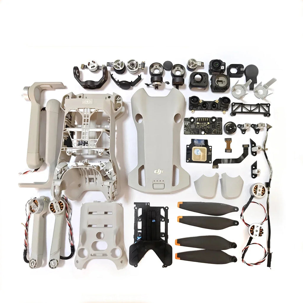 Disassembled DJI drone parts including motors, propellers, drone body, gimbal components, and circuit boards on white background